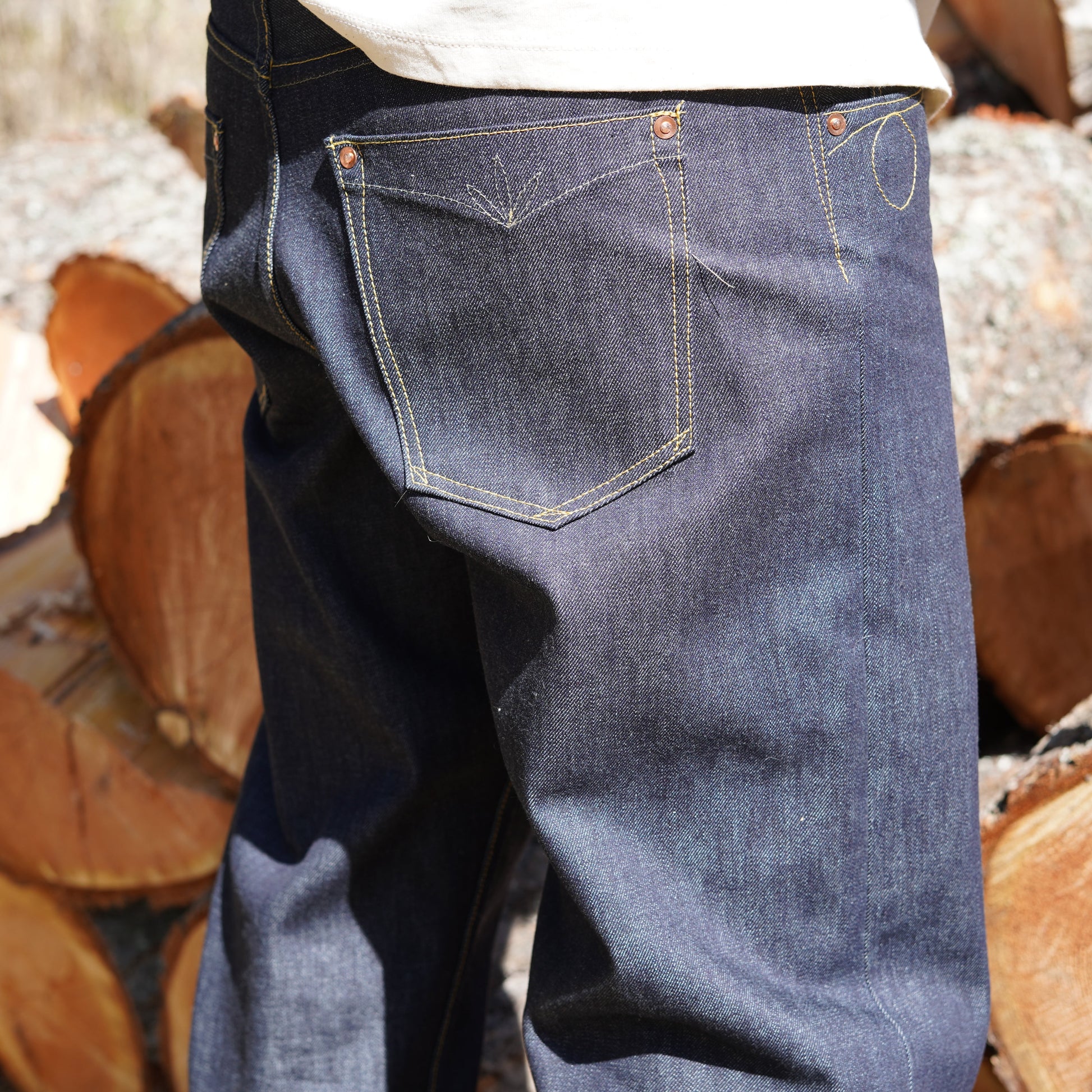 Side view of Rag Proper Overalls hand stitched custom high rise straight leg denim