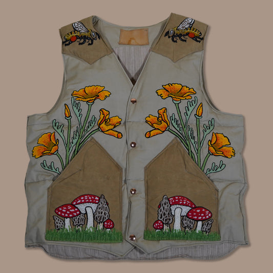 Custom embroidered and hand stuff down vest celebrating the rite or spring with poppys and mushrooms